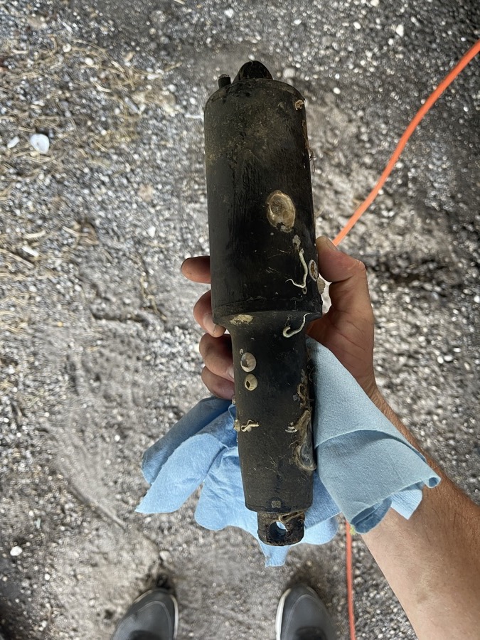 Trim tab actuator crusted with barnacles, removed from a customer boat