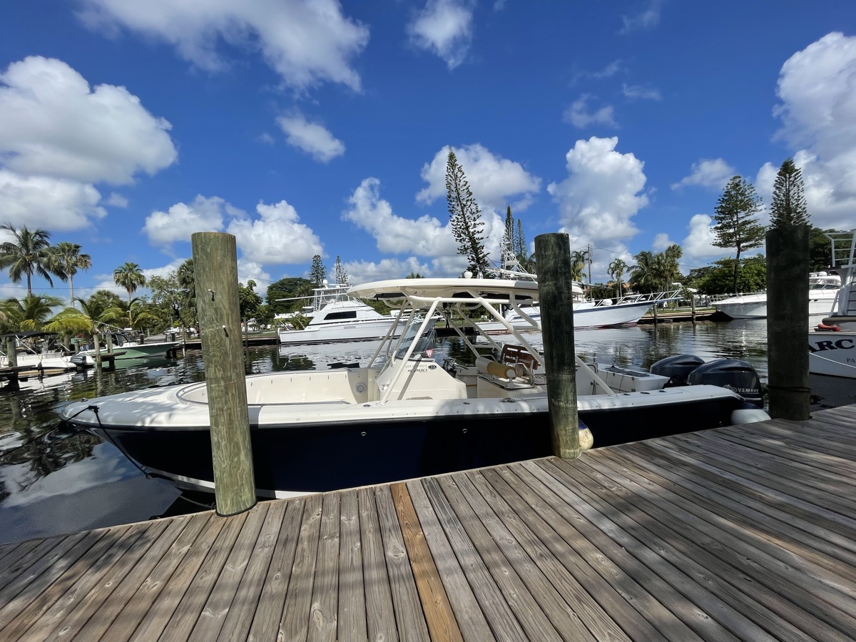 Center console with twin Yamaha outboards at the dock