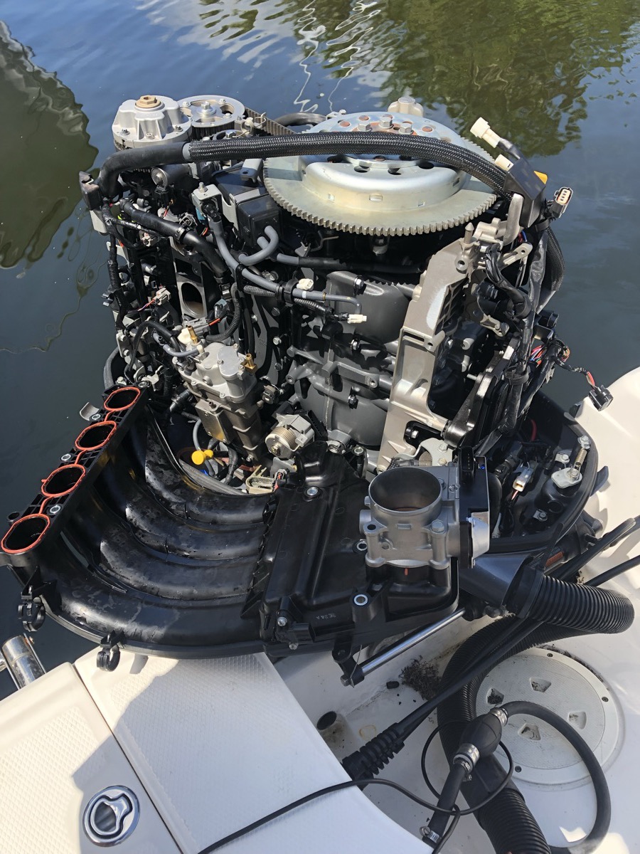 Outboard powerhead open for diagnostics on the water