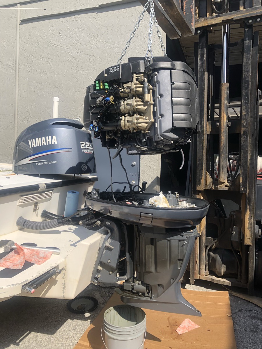 Yamaha outboard powerhead lifted for rebuild